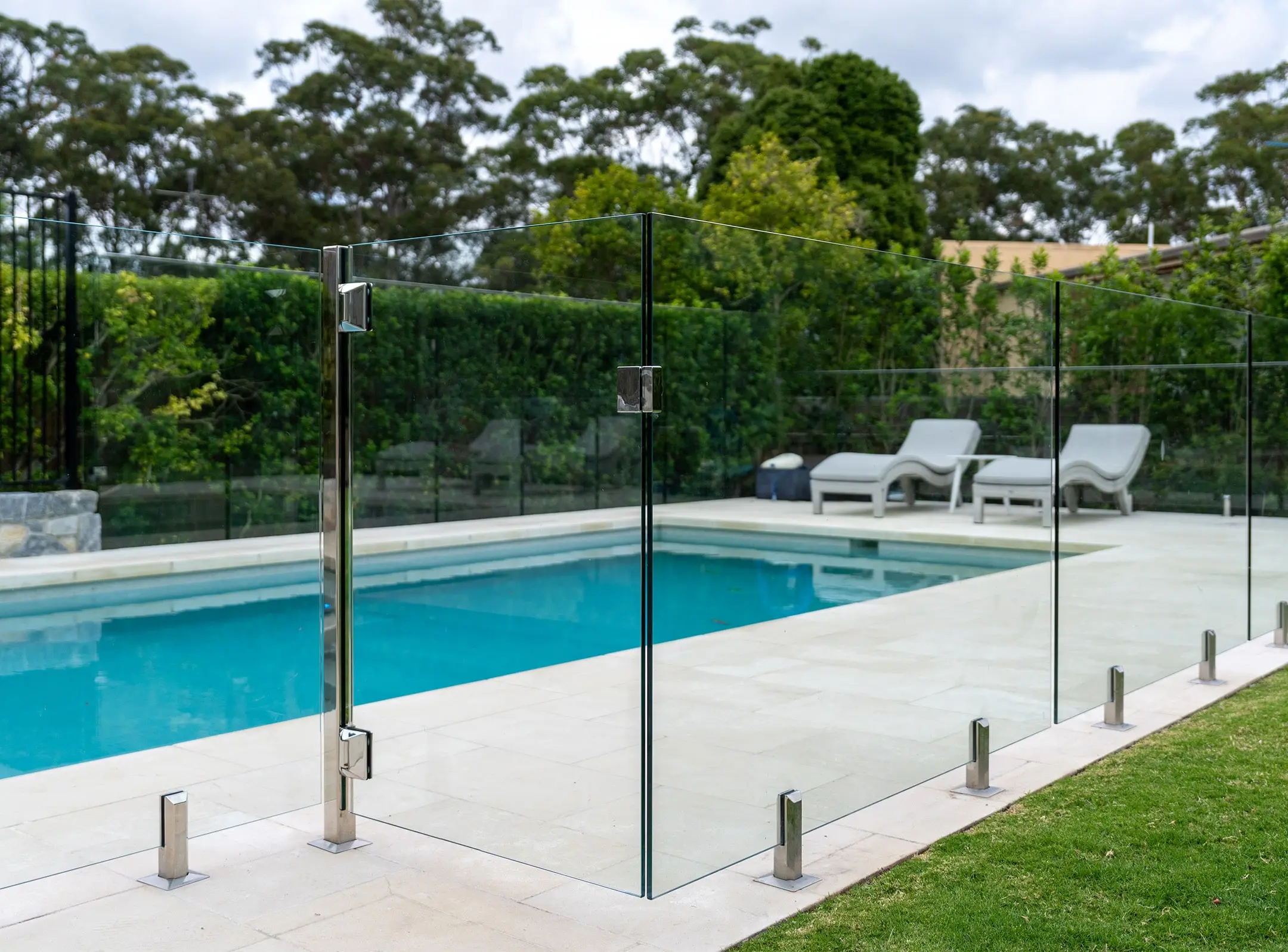 Glass pool safety fence Dubai around luxury swimming pool with clear visibility
